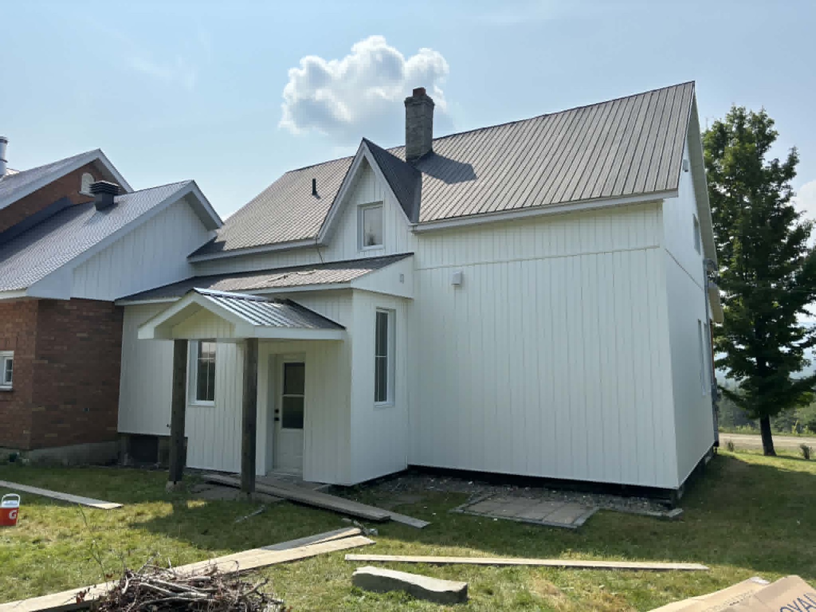 Maison de campagne blanche avec toiture d'acier neuve